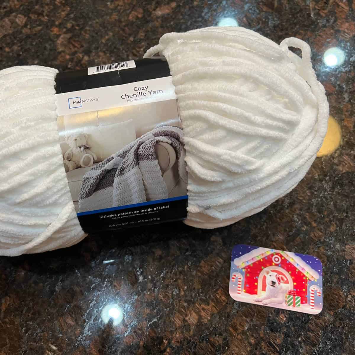 White chenille yarn next to a Target gift card.