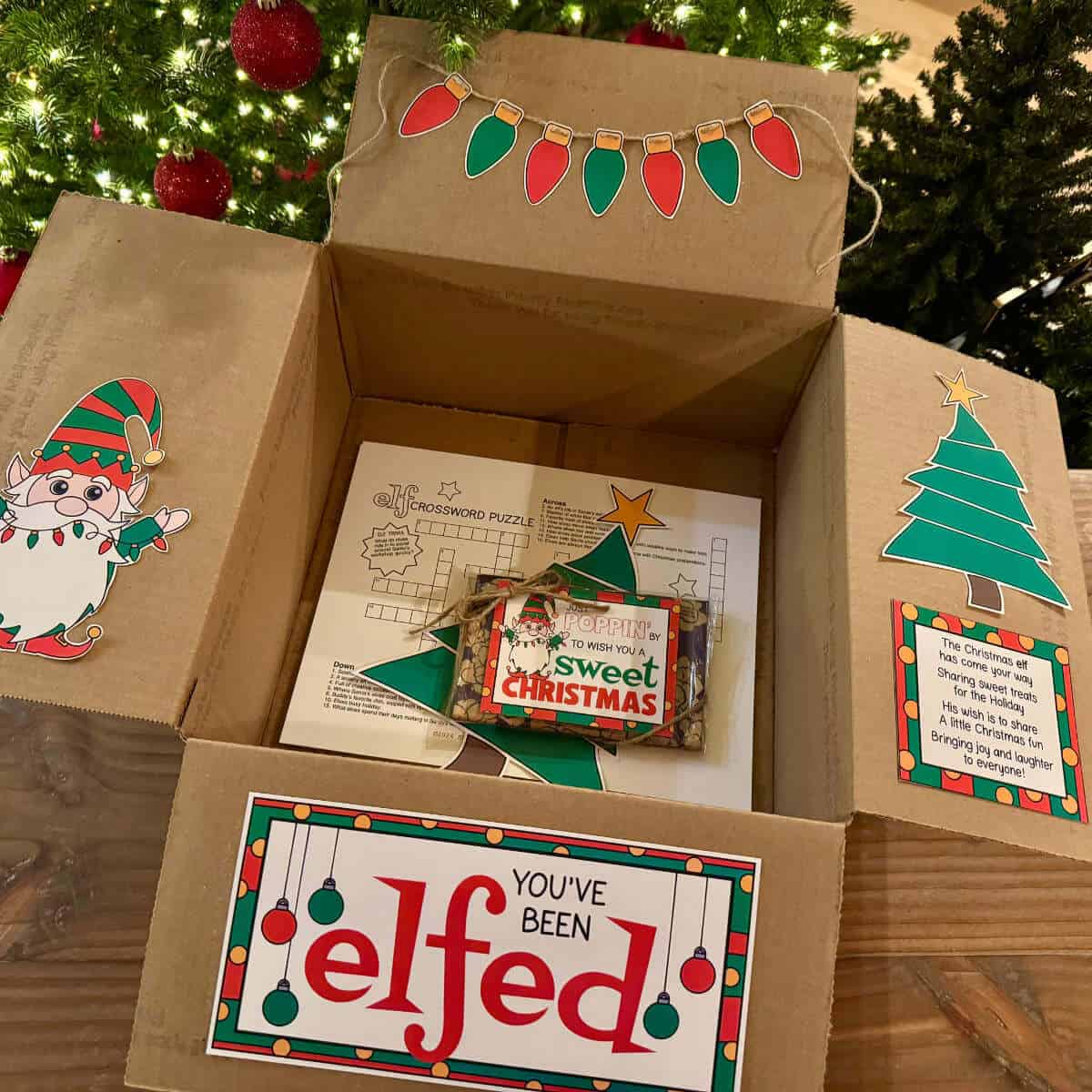 You've Been Elfed care package box with printables decorating the box flaps.