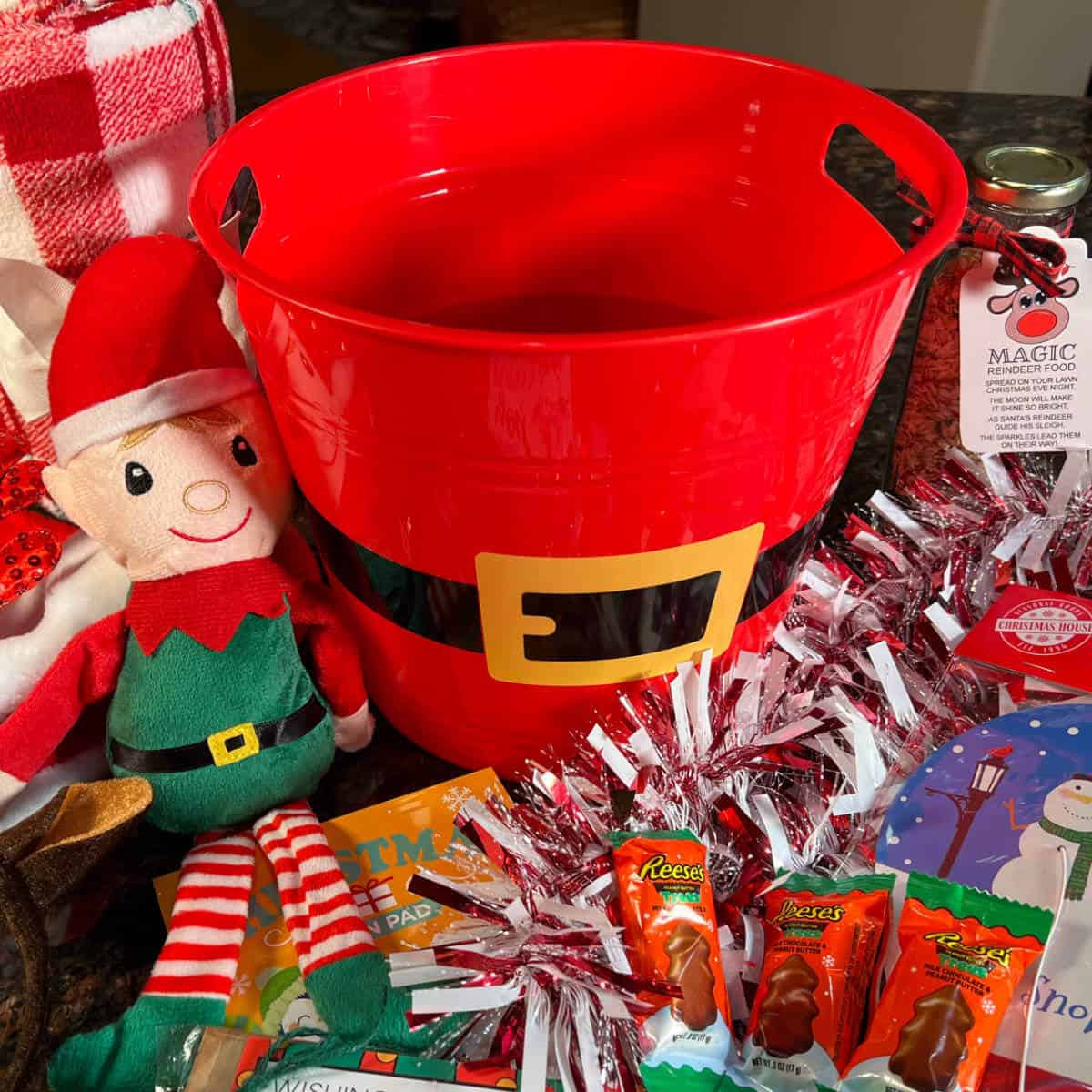 Festive Christmas items laid out ready to put in a Christmas bucket.