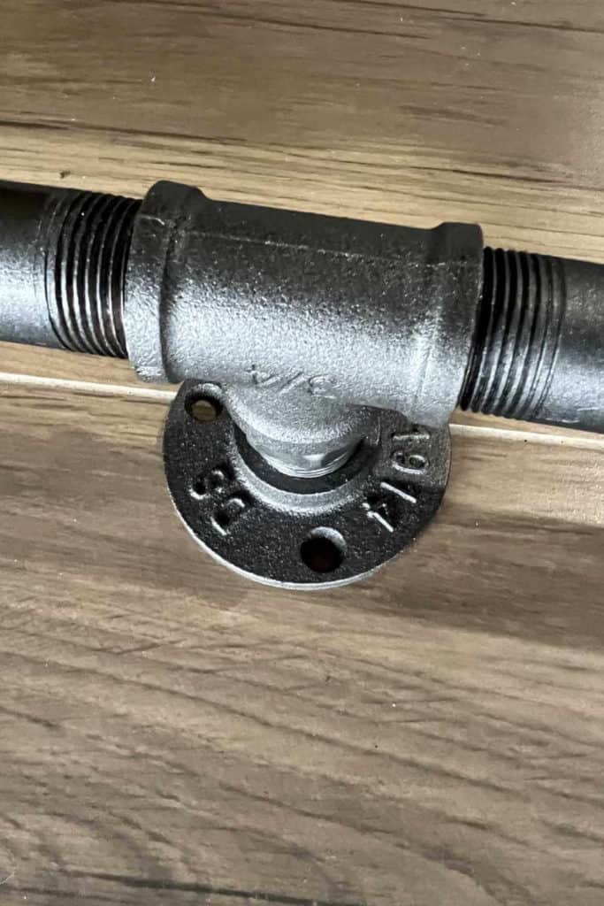 Center brace for industrial pipe curtain rod.