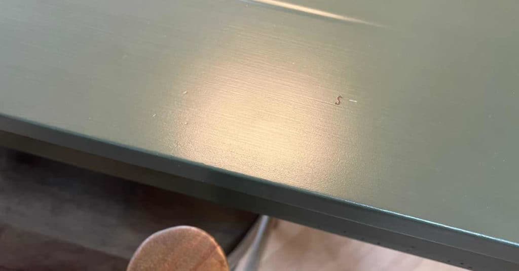 Tiny S on painted kitchen table where a bit of vinyl was left from another project.
