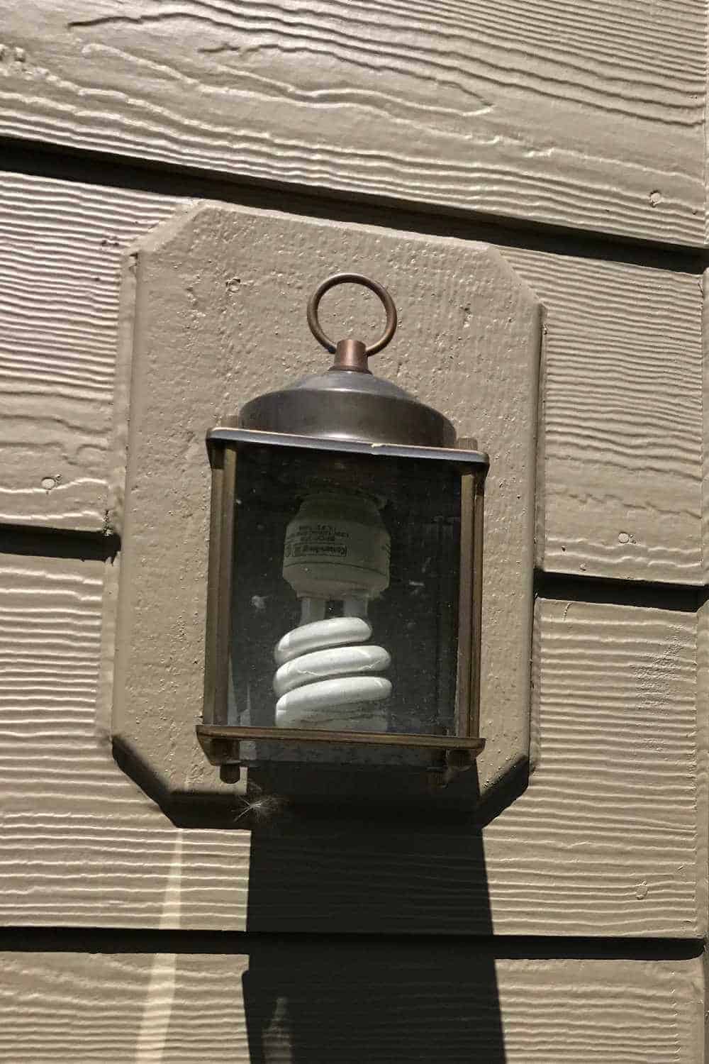 Old light fixture with coil fluorescent bulb.