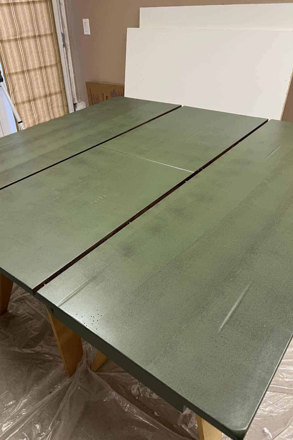 Painting a kitchen table with Fusion Mineral Paint in the color Bayberry.