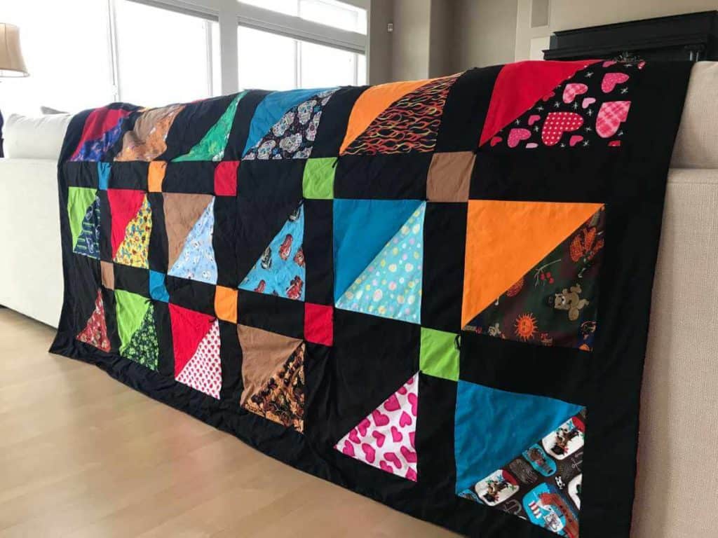 Quilt made out of dog bandanas.