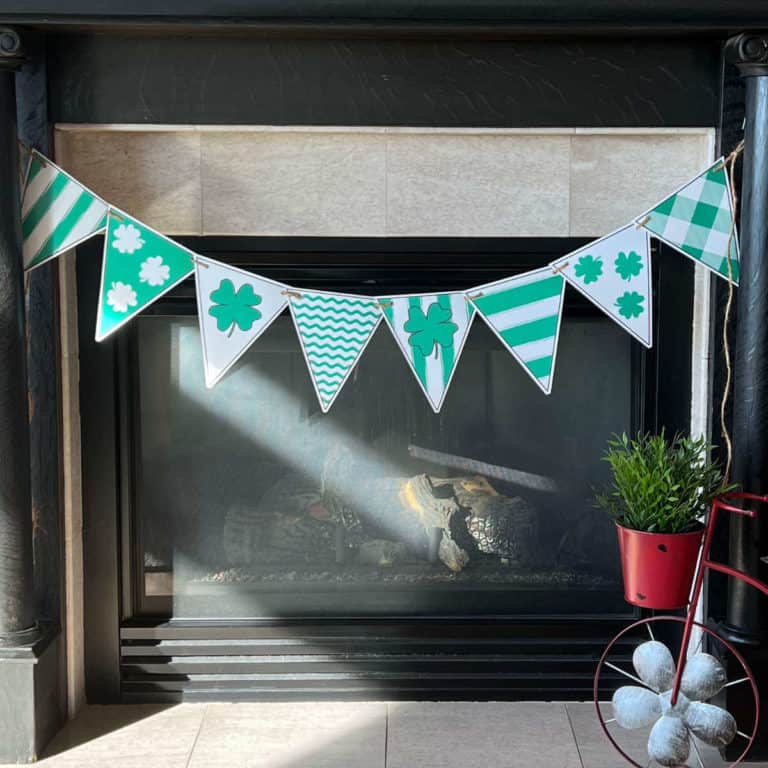 A St. Patrick's Day Banner hung from a fireplace mantel.