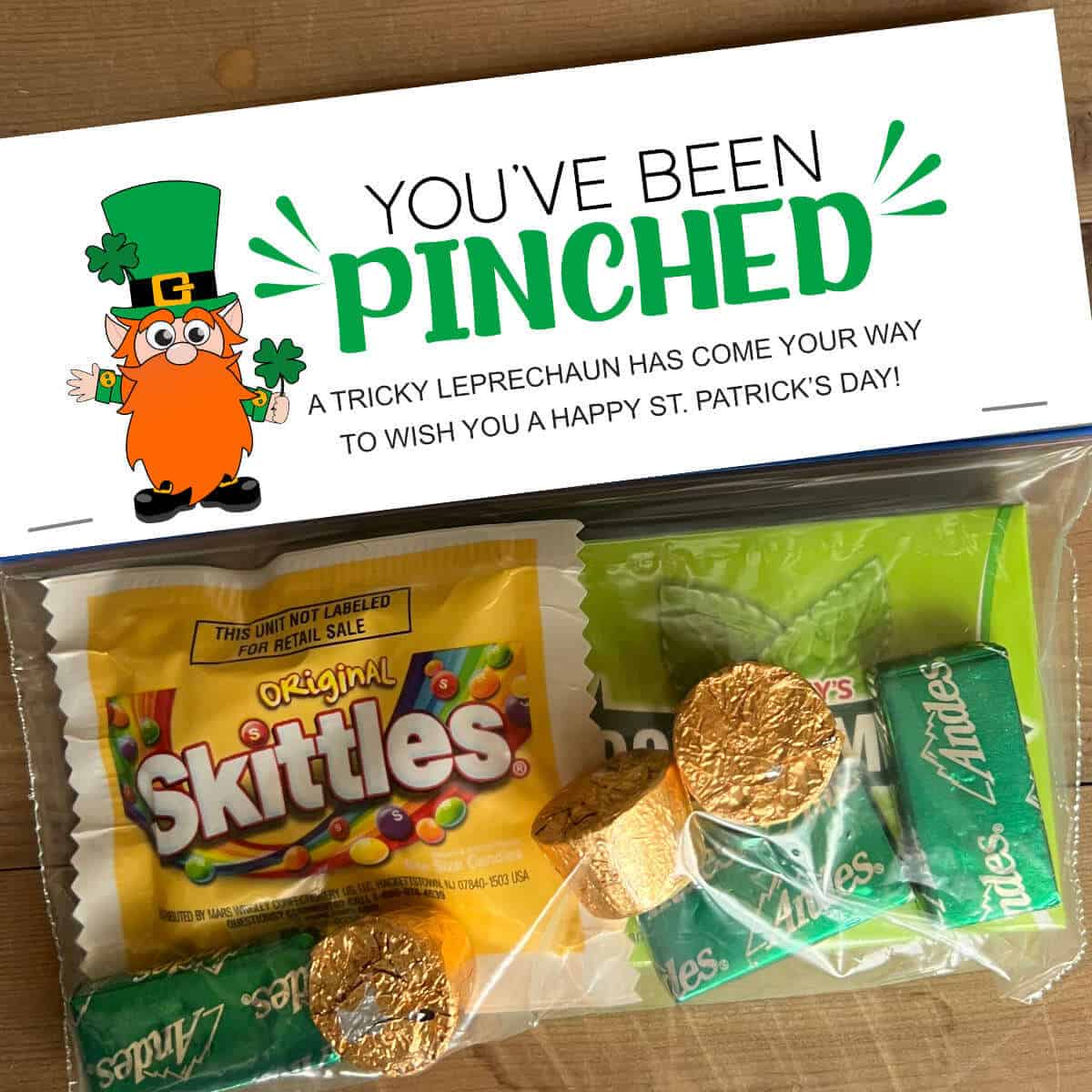 A snack size baggie full of St. Patrick's Day treats with a bag topper that says, You've Been Pinched.