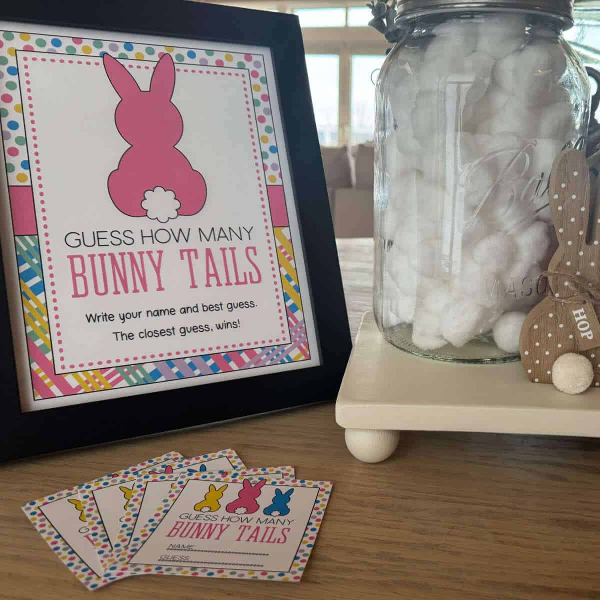 A large jar full of cotton balls next to a sign that says, Guess How Many Bunny Tails.