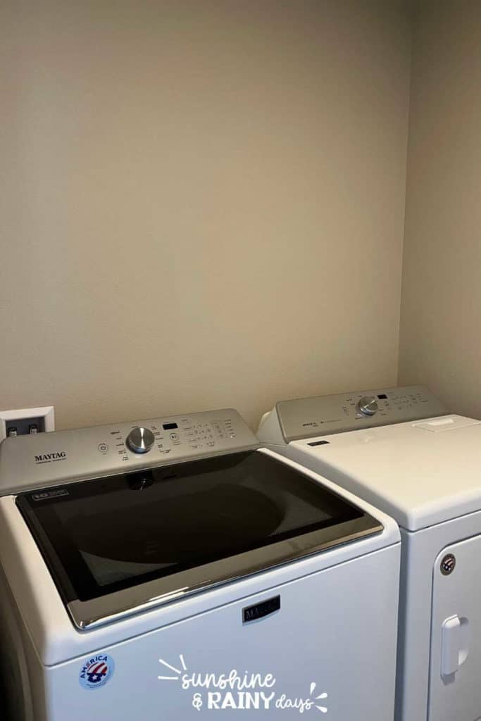 Blank wall above washer and dryer.