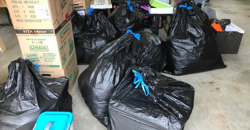 Bags and boxes full of stuff for a garage sale.