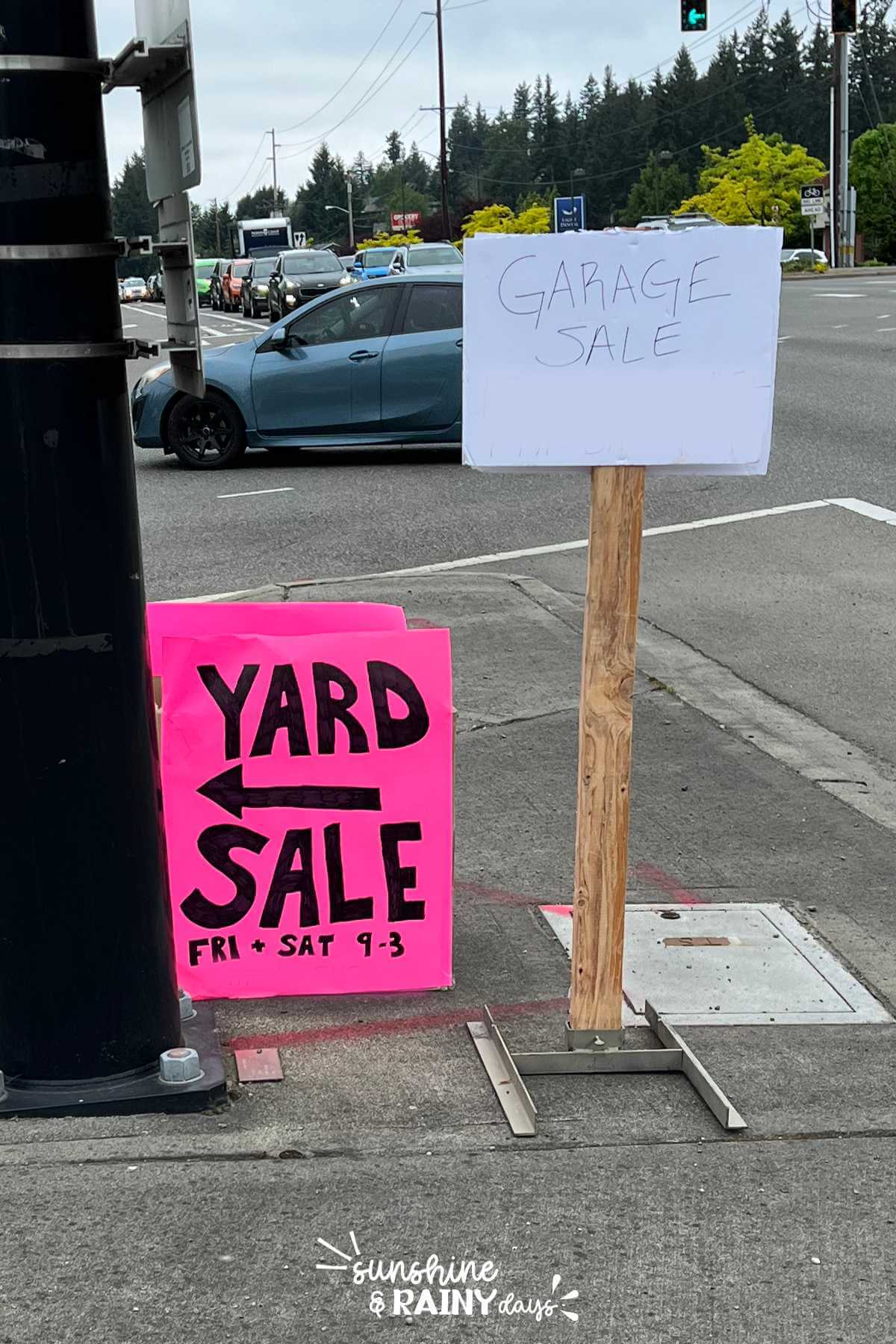 Garage Sale Signs at a busy intersection.