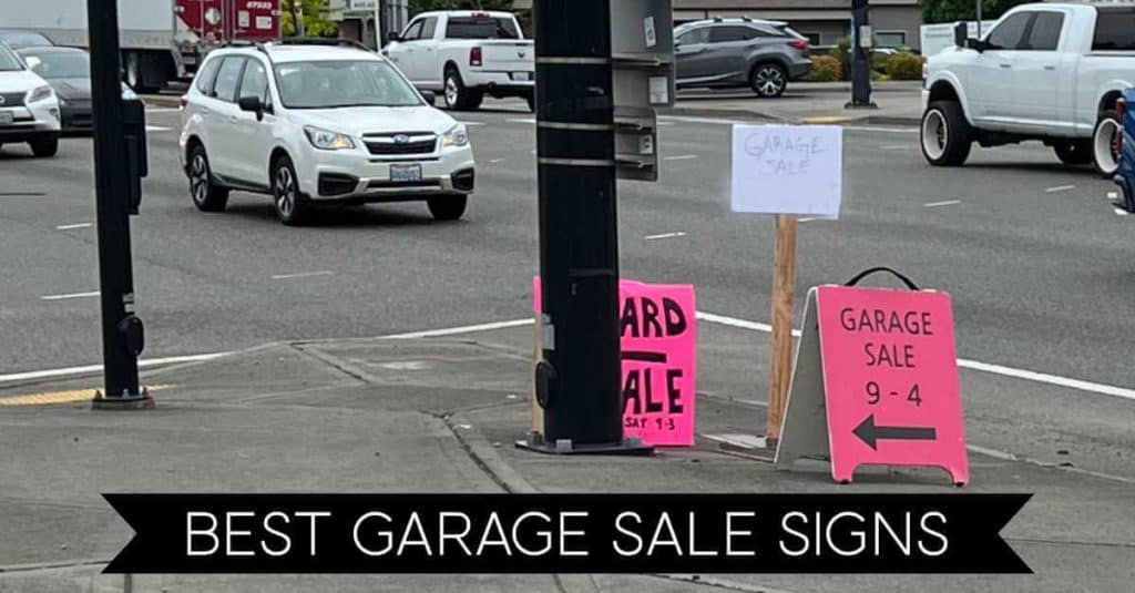 Garage sale signs at a busy intersection.