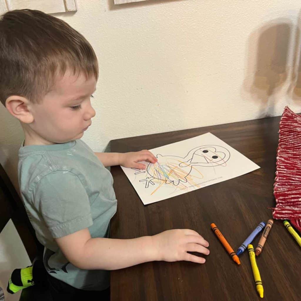 Little boy coloring a turkey.