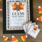 Thanksgiving Guess How Many sign with guess cards and clipart candy corn laying on a table.