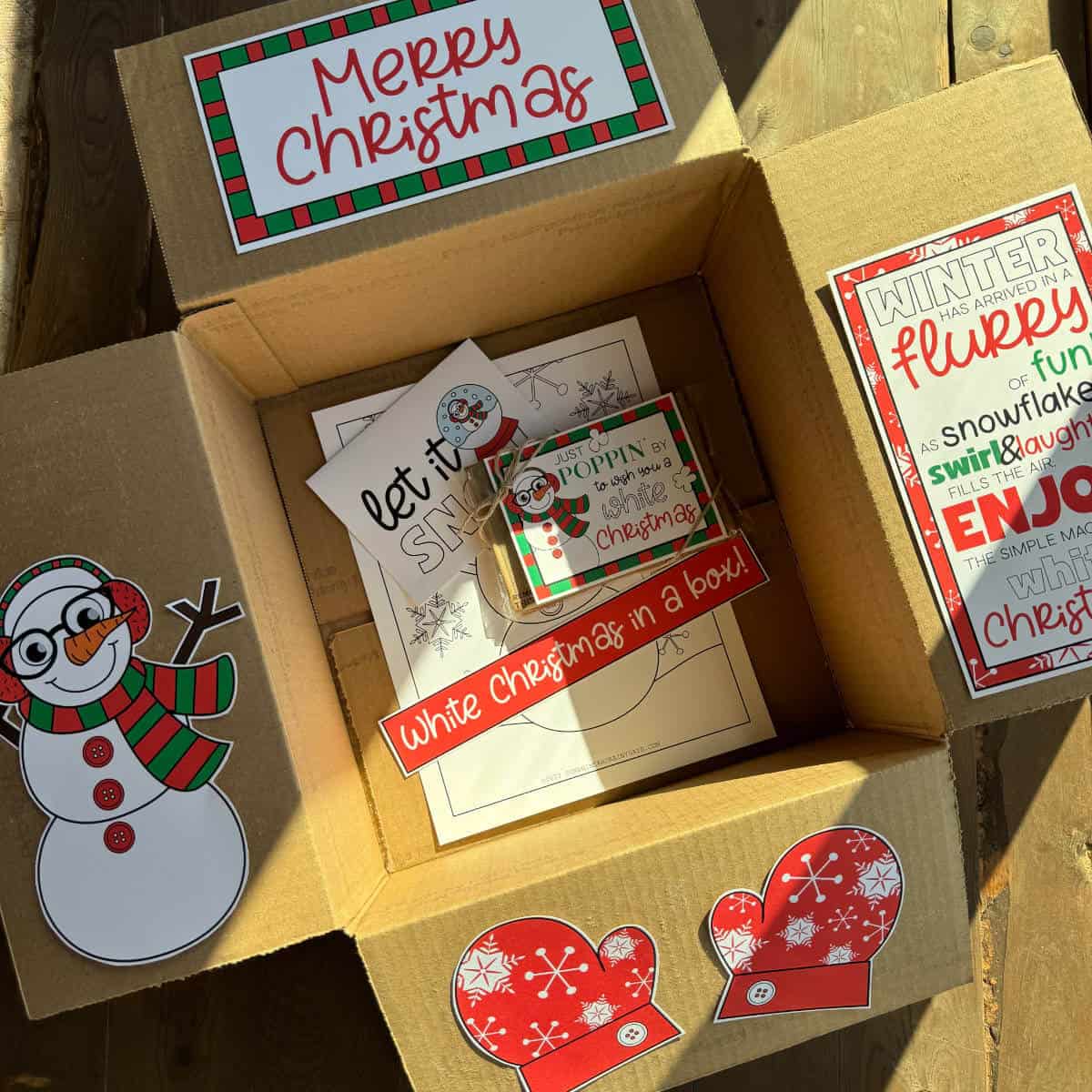 Image of a box with printable shapes on the box flaps in a White Christmas theme.
