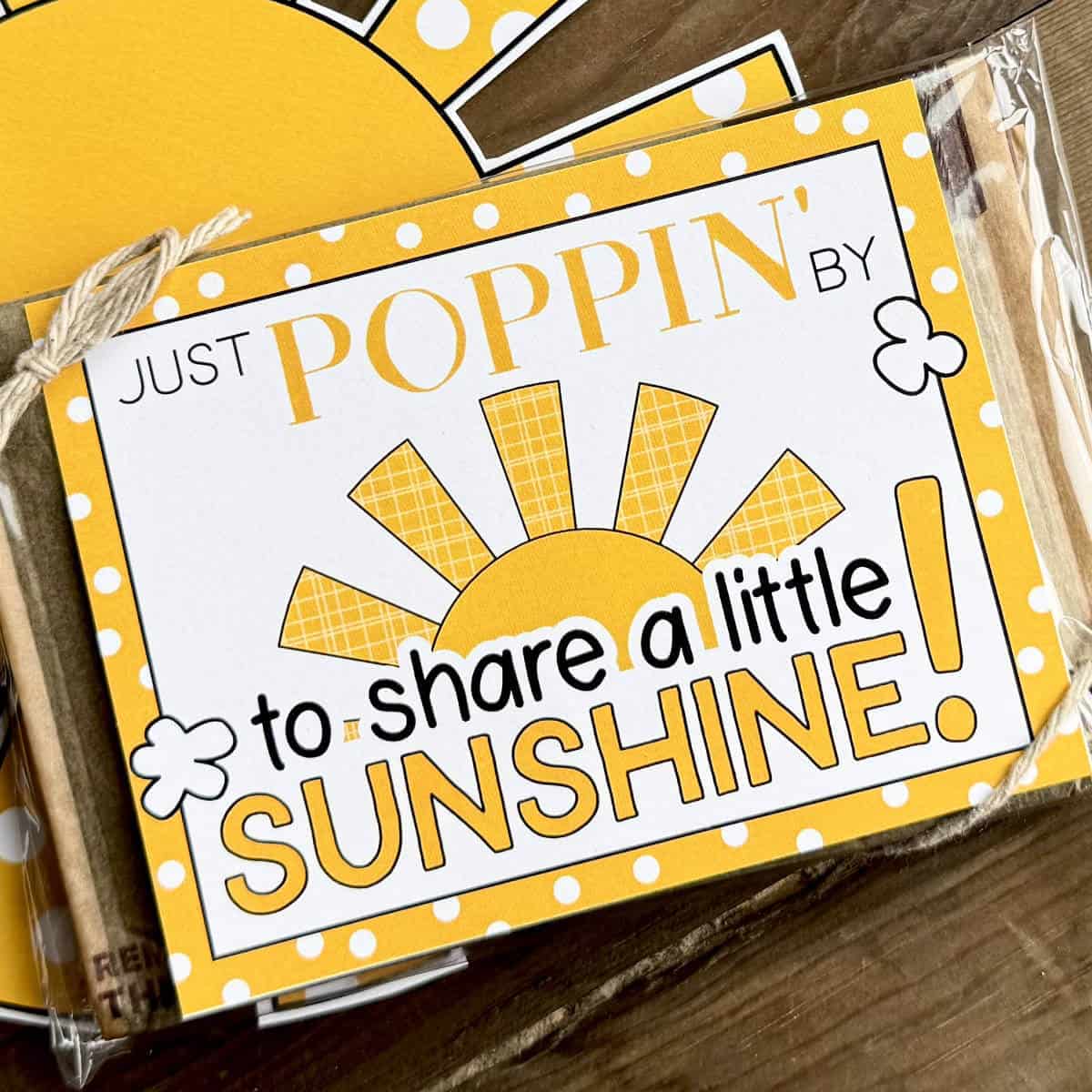 Image of a sunshine popcorn tag on a bag of microwave popcorn with a printable sun in the background.