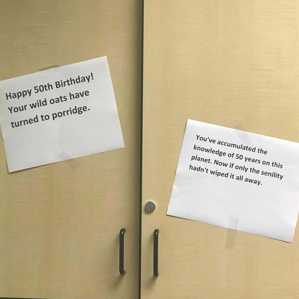 Funny sayings taped to a principal's cabinets for his 50th Birthday.