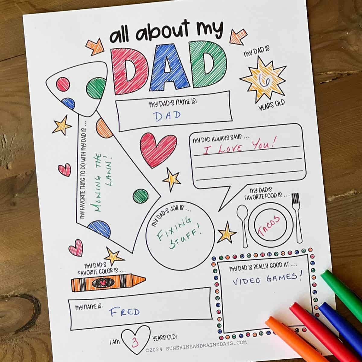 All about dad printable coloring page with prompts laying on a table with felt tip markers.