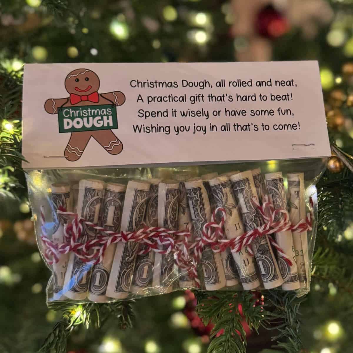 Snack-size baggie full of rolled bills with a baggie topper that has a poem about Christmas Dough.