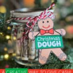 A jar of rolled up bills tied with baker's twine with a gingerbread man tag that says Christmas Dough.