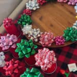 Christmas bows on the outside edge of a lazy Susan and on upside down Solo cups.