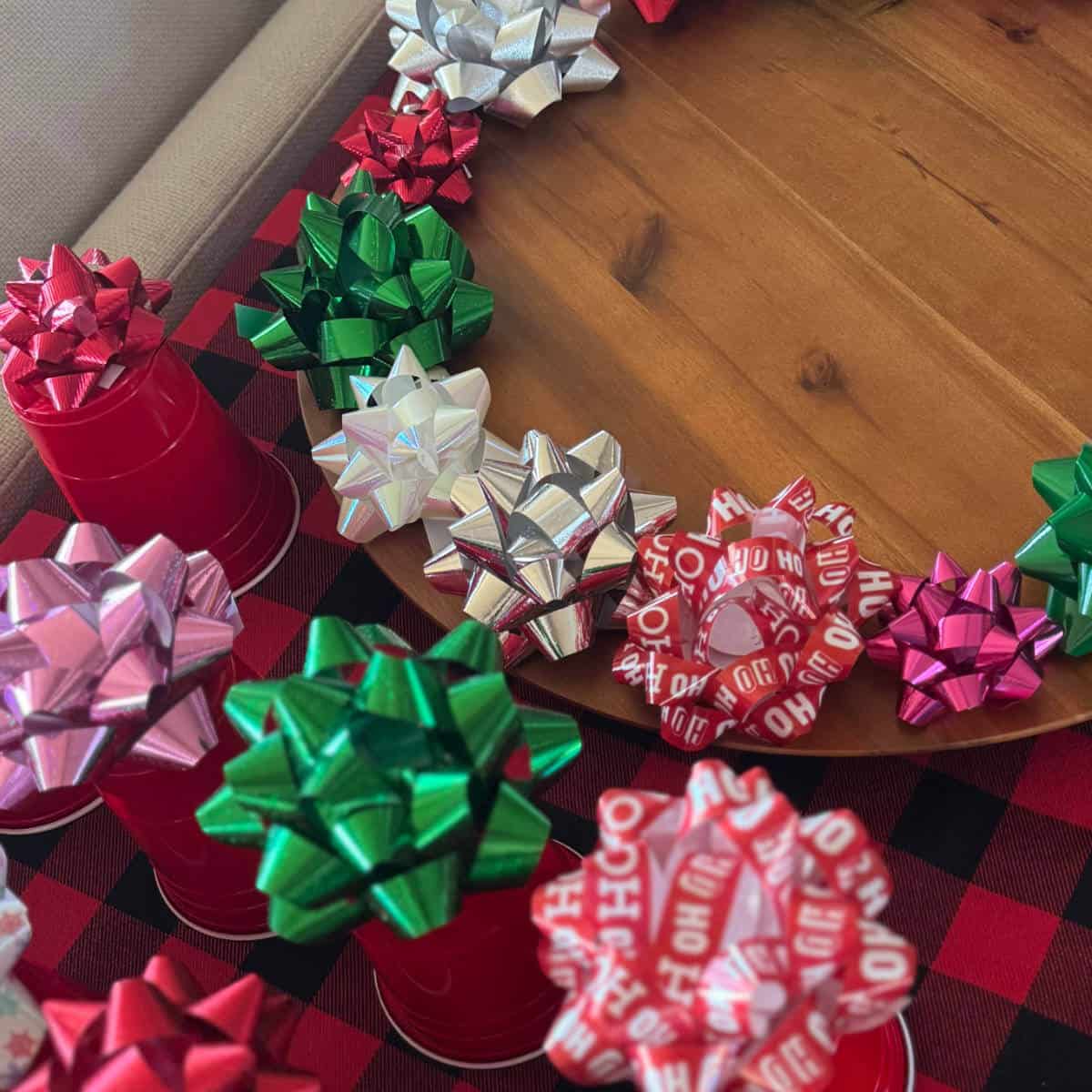 Christmas bows around the edge of a lazy Susan and on upside down cups.