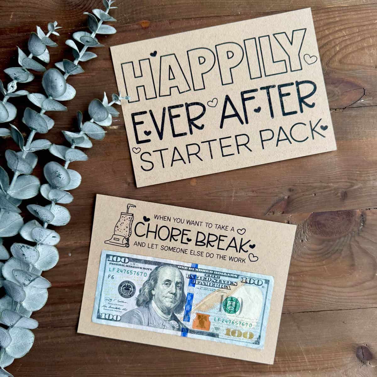 Two pages printed that say Happily Ever After Starter Pack and Chore Break with a fake plant nearby.