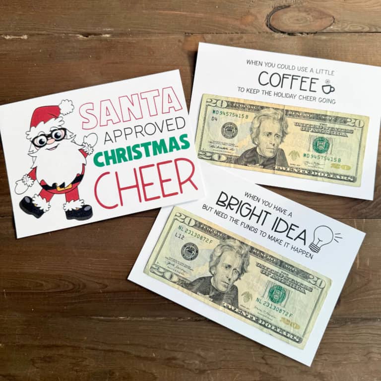 Image of three pages from a Christmas gift card book. Two of the pages have twenty dollar bills attached.