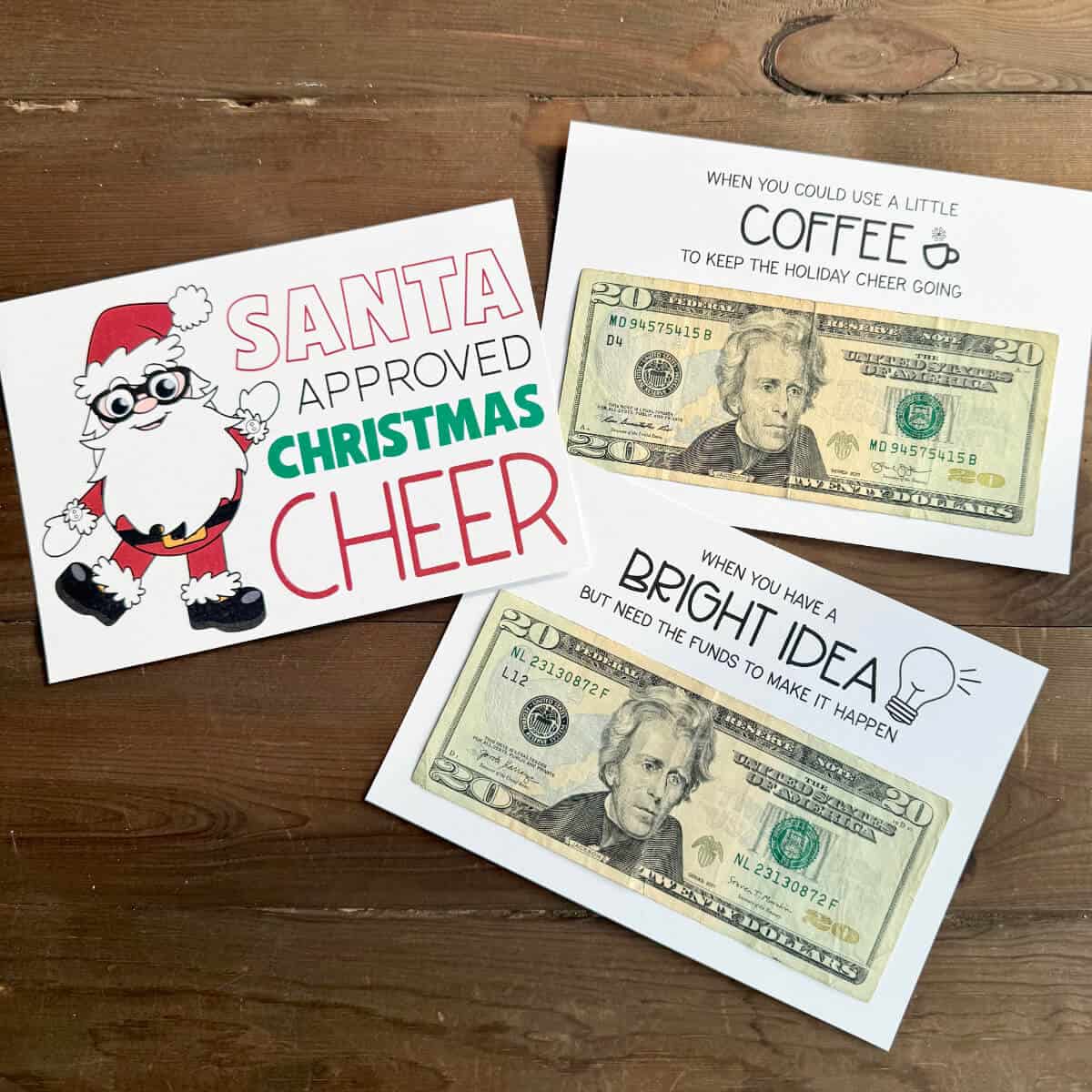 Image of three pages from a Christmas gift card book. Two of the pages have twenty dollar bills attached.