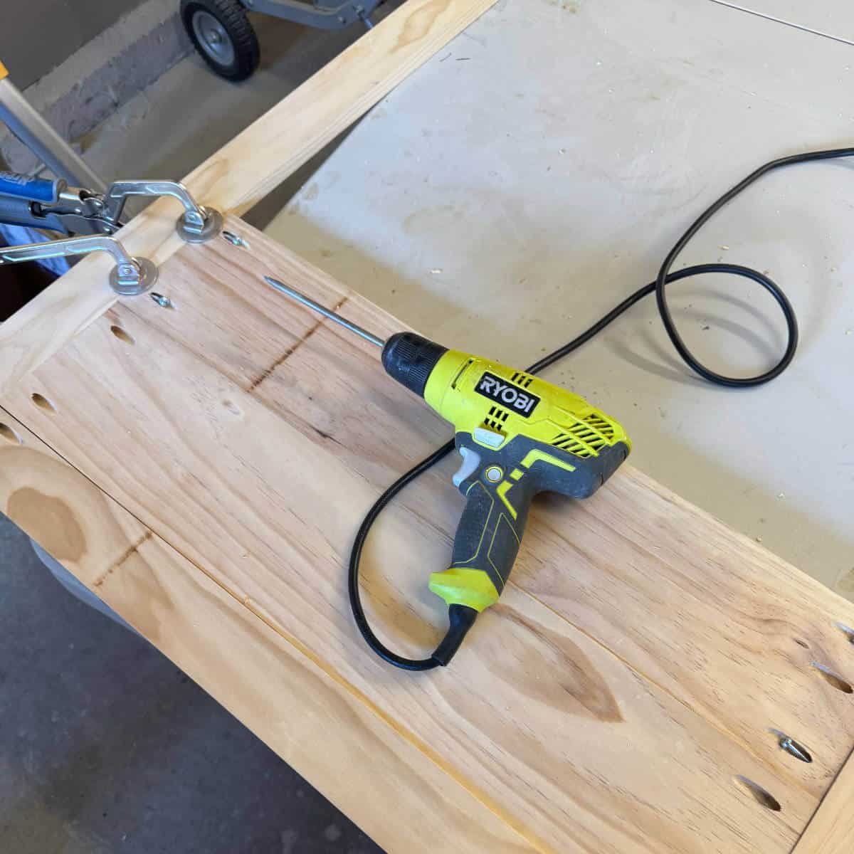 Image of a wood frame clamped with a drill.