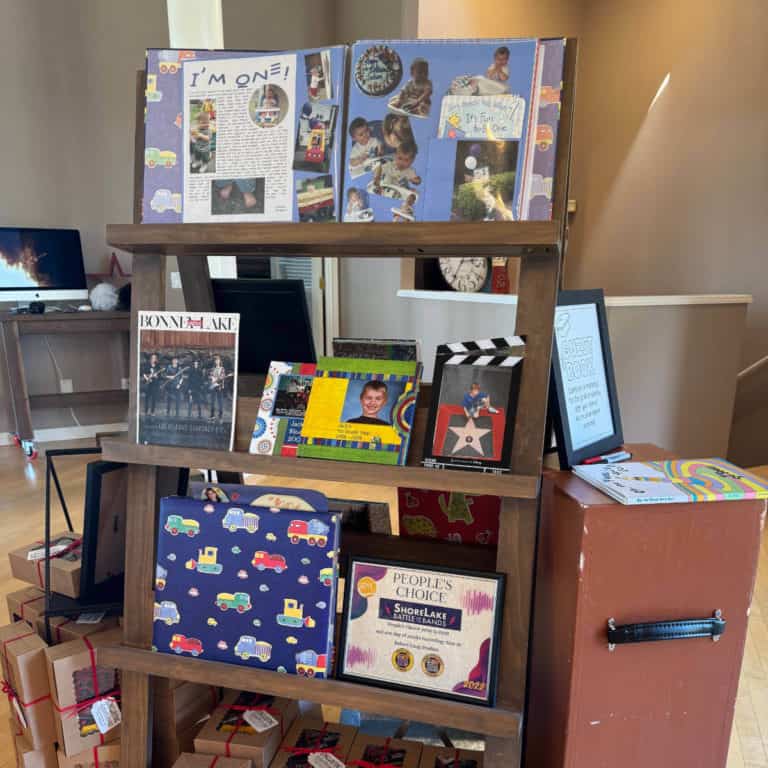 Graduation photo display with scrapbooks, pictures, and awards displayed on it.