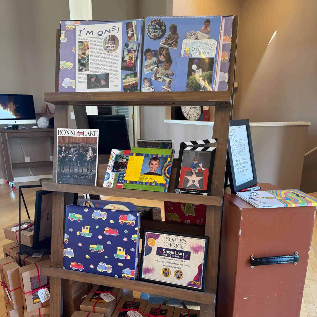 Graduation photo display with scrapbooks, pictures, and awards displayed on it.