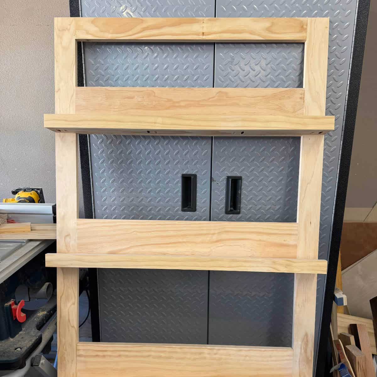 Image of one side of a photo display built and leaning on a gladiator cabinet.