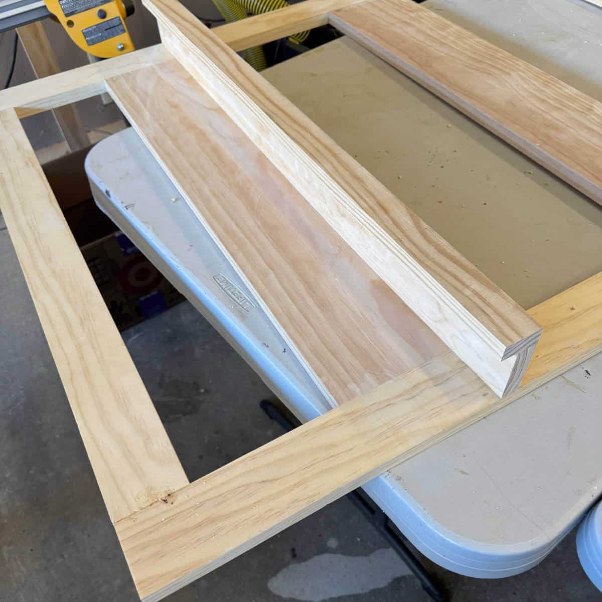 Image of a wood frame with a shelf attached.