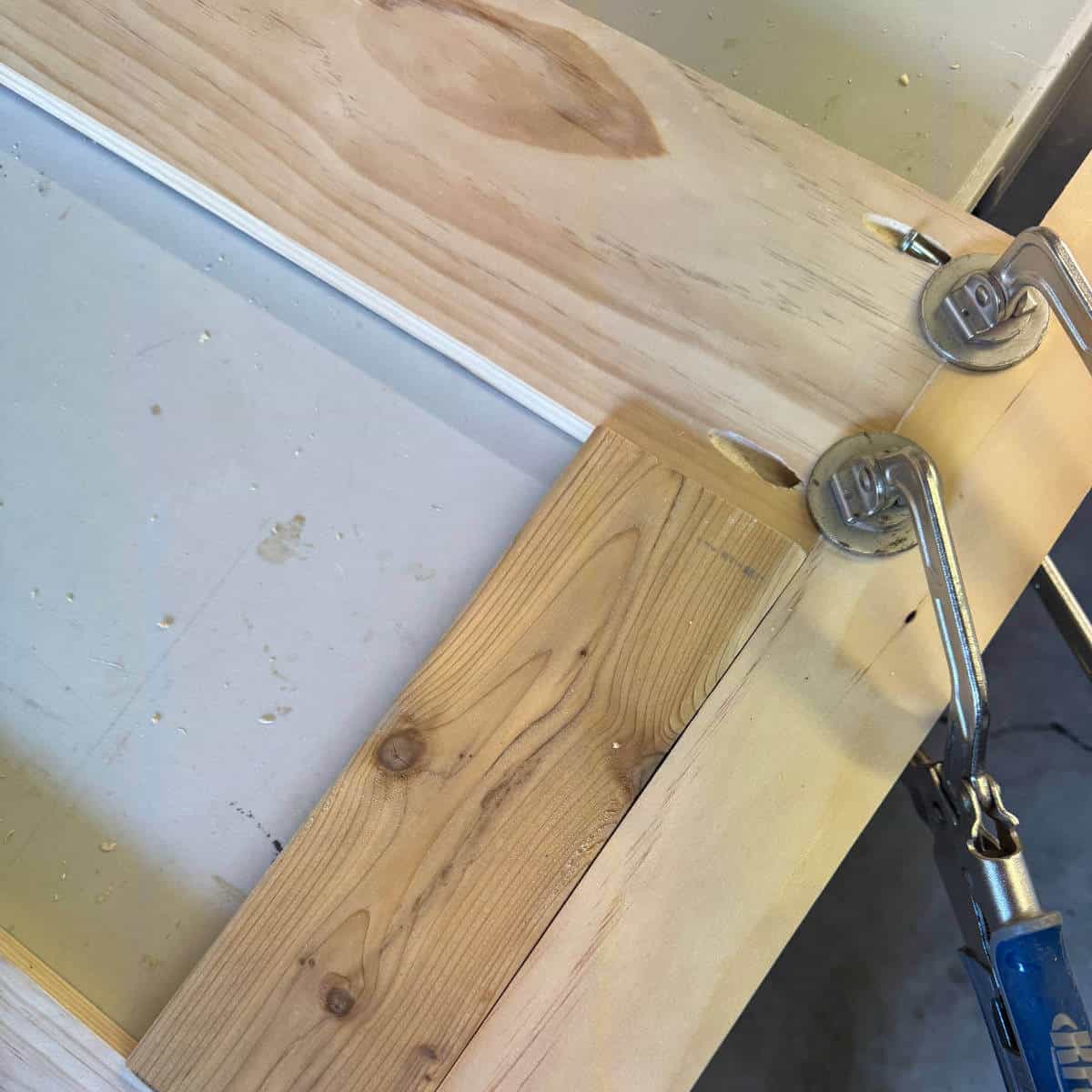 Image of wood with a wood spacer and clamps.