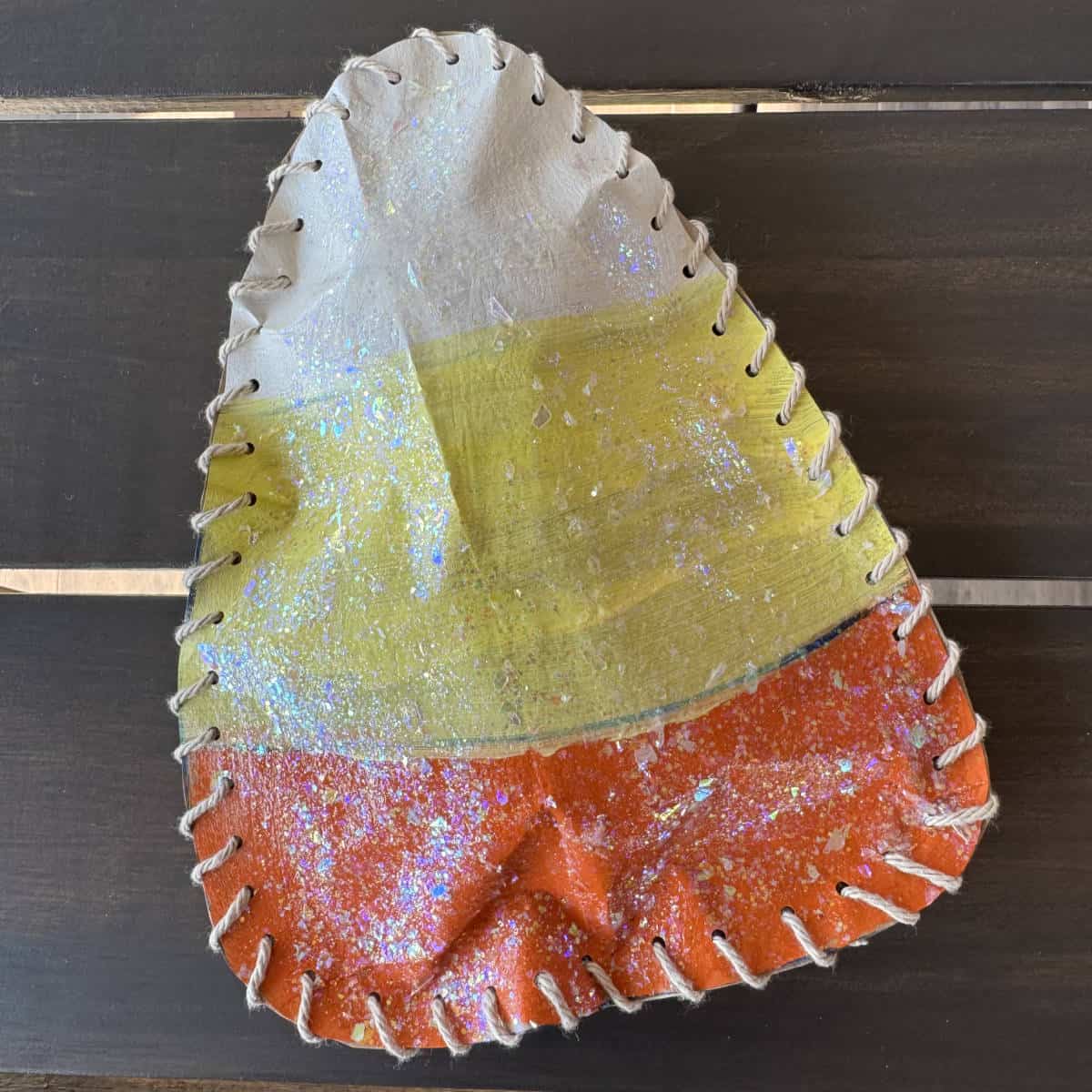 Finished paper bag candy corn laying on a table.