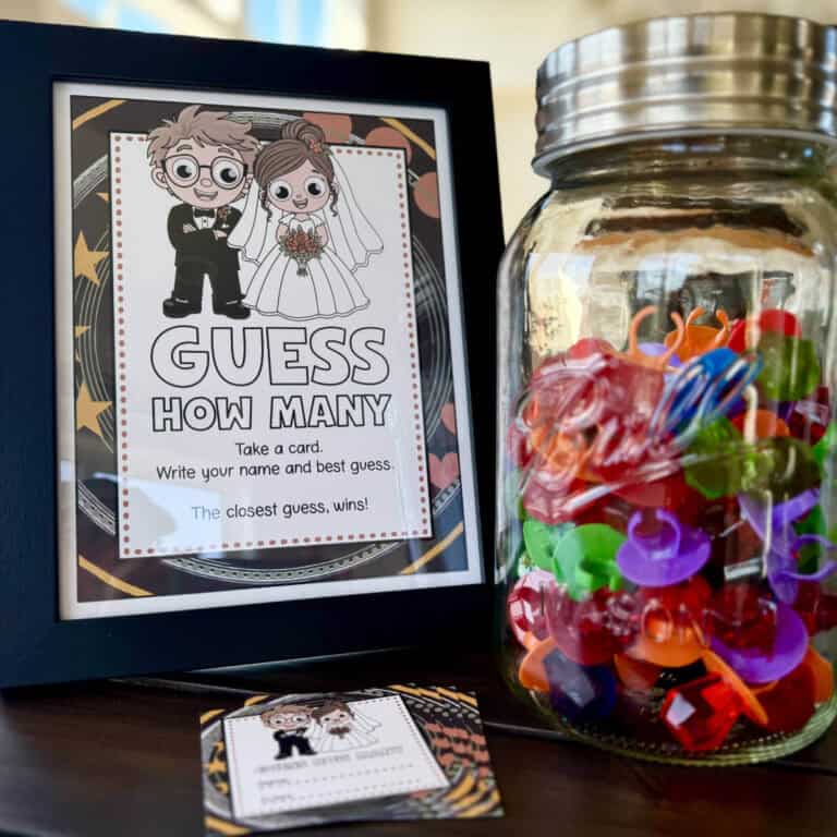 Image of a sign with a clipart bride and groom that says guess how many next to a jar filled with ring pops.