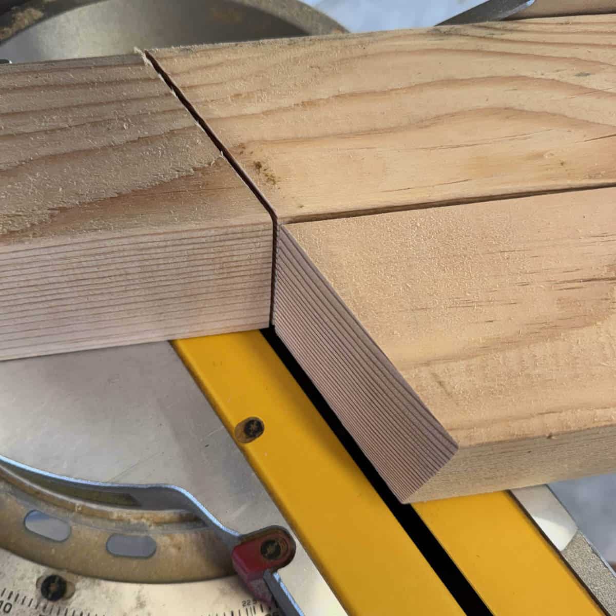 Image of 4x4 being cut on a saw.
