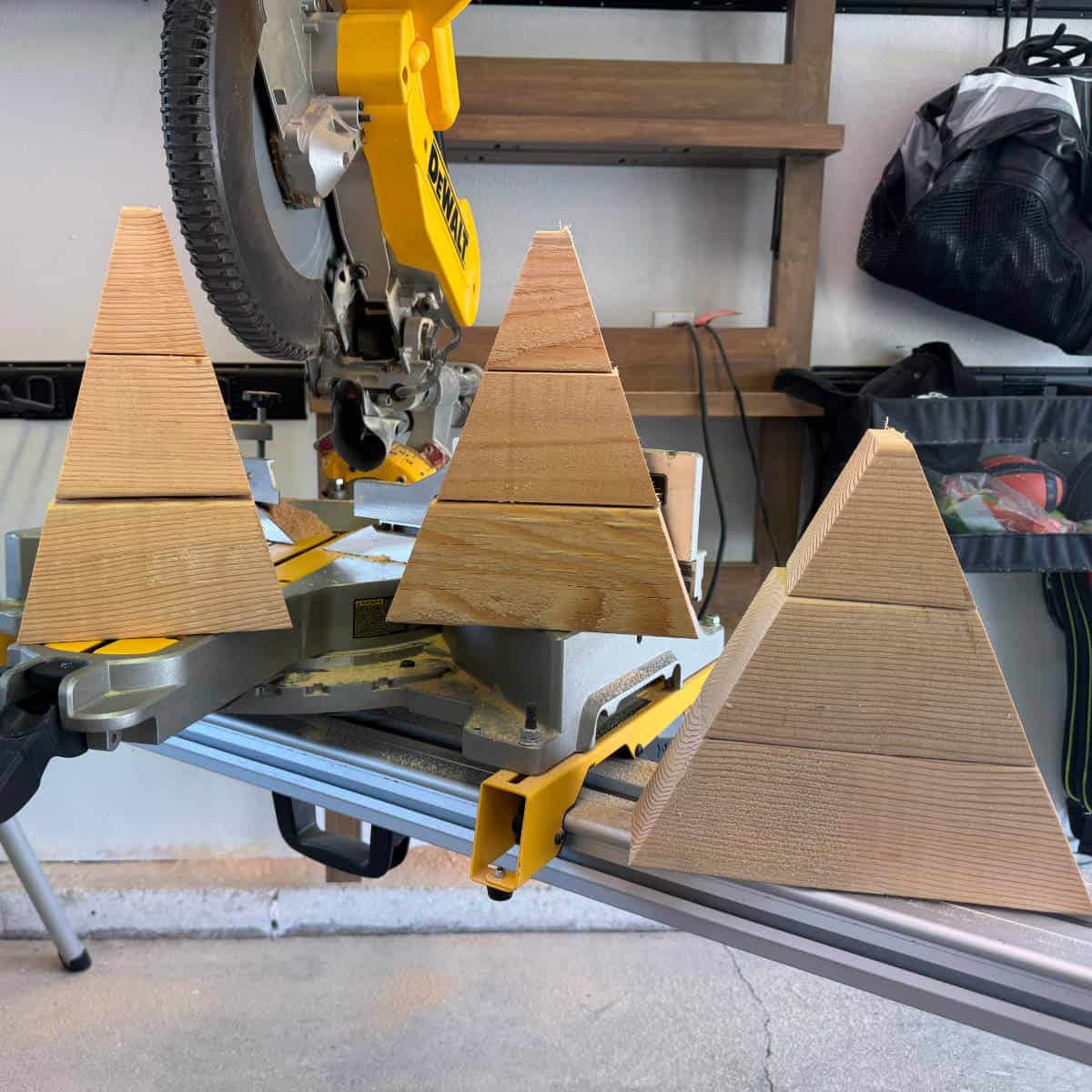 Image of three different candy corn shapes sitting on top of a saw.