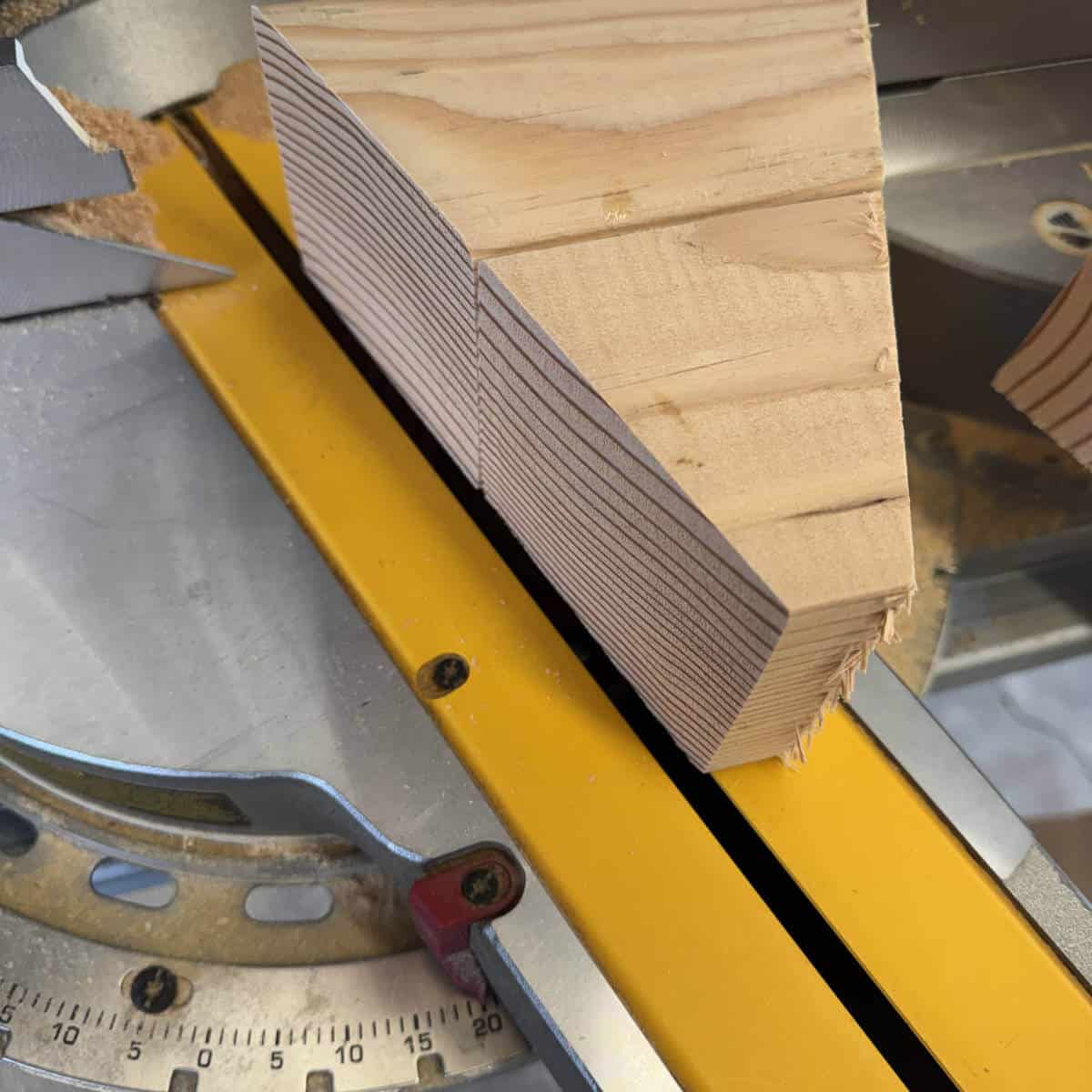 Image of cutting a 4x4 into incremental shapes to make a candy corn shape.