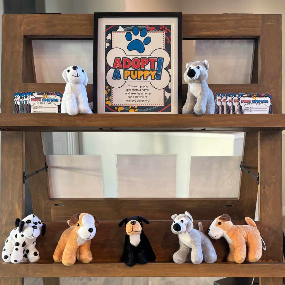 Image of small stuffed puppies on display with a sign that says Adopt A Puppy!